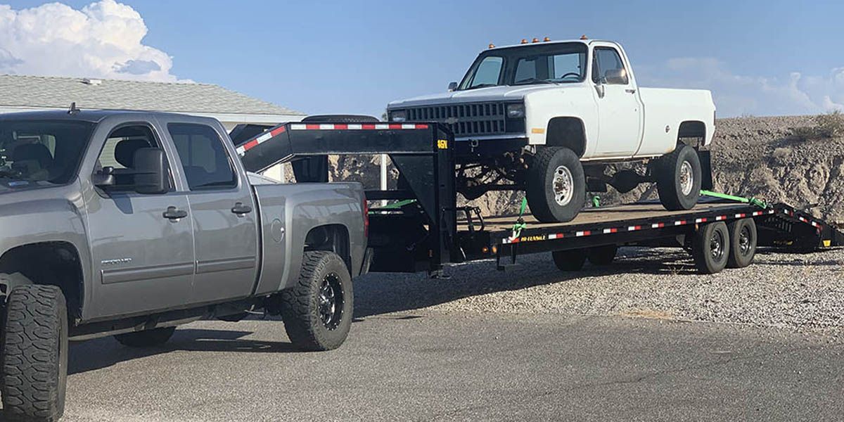 pickup truck getting hauled on a trailer