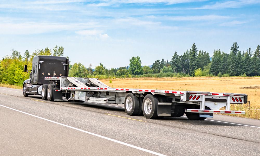 Step deck trailer with upper deck loading ramps