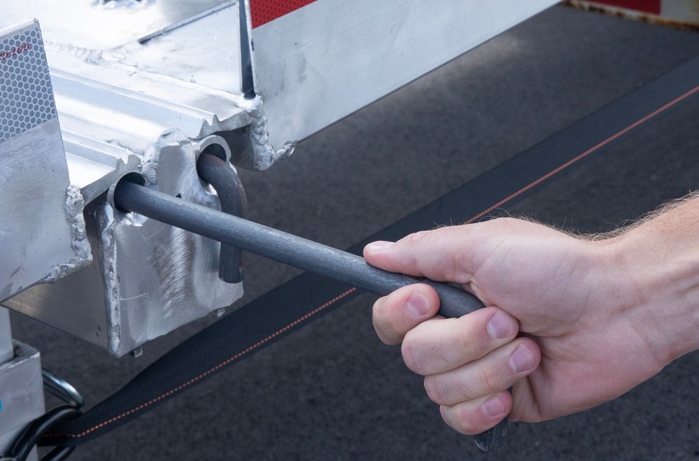 man placing a pin-on end on HD Ramps portable aluminum yard ramp