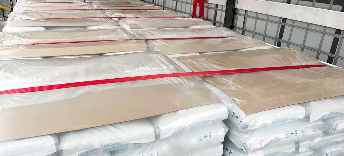 red bundling straps around pallet of product in trailer